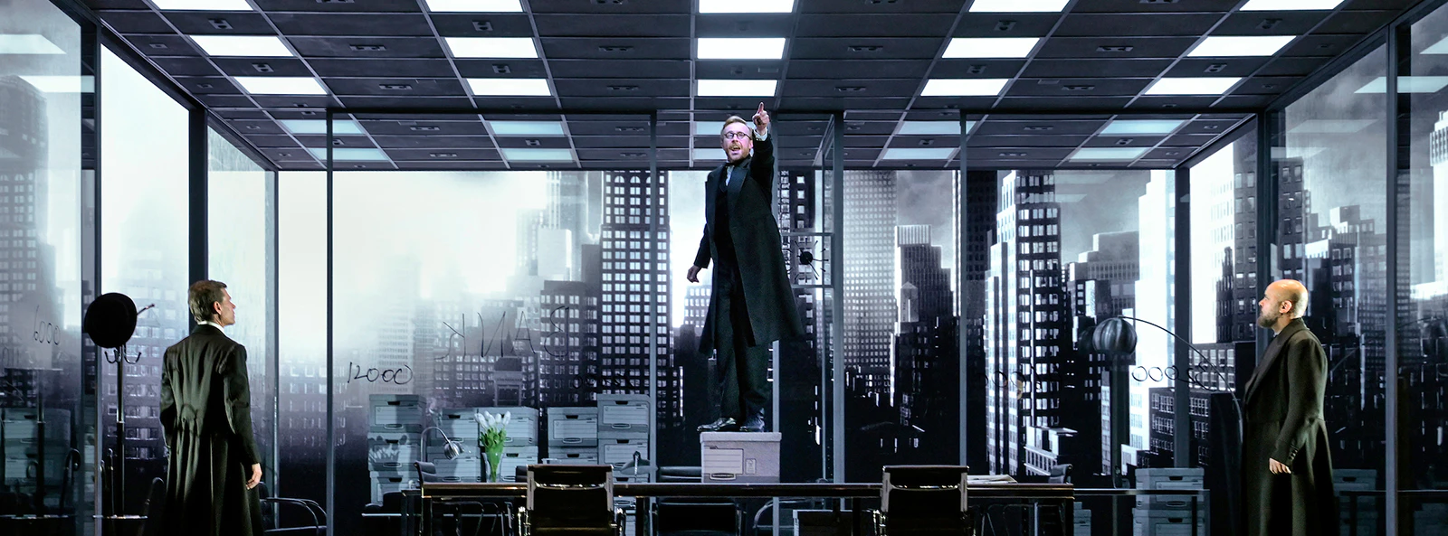 Stage scene from "The Lehman Trilogy" with actors in an office setting.