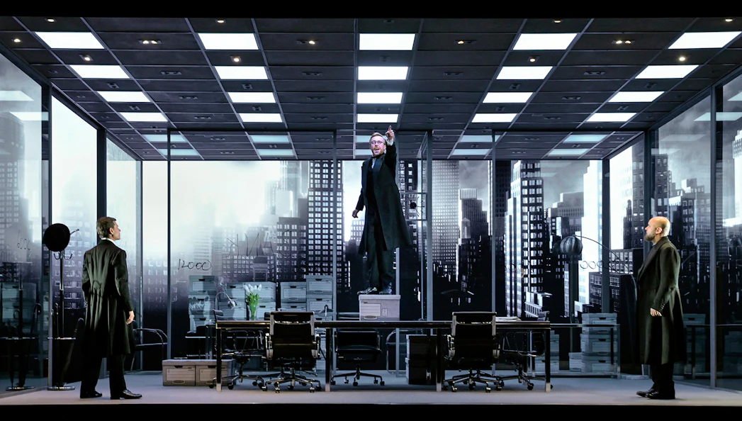 Stage scene from "The Lehman Trilogy" with actors in an office setting.