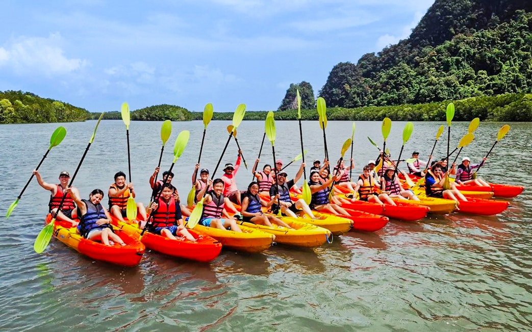 Tourists kayaking at Ao Thalane, Thailand, through mangrove forests.