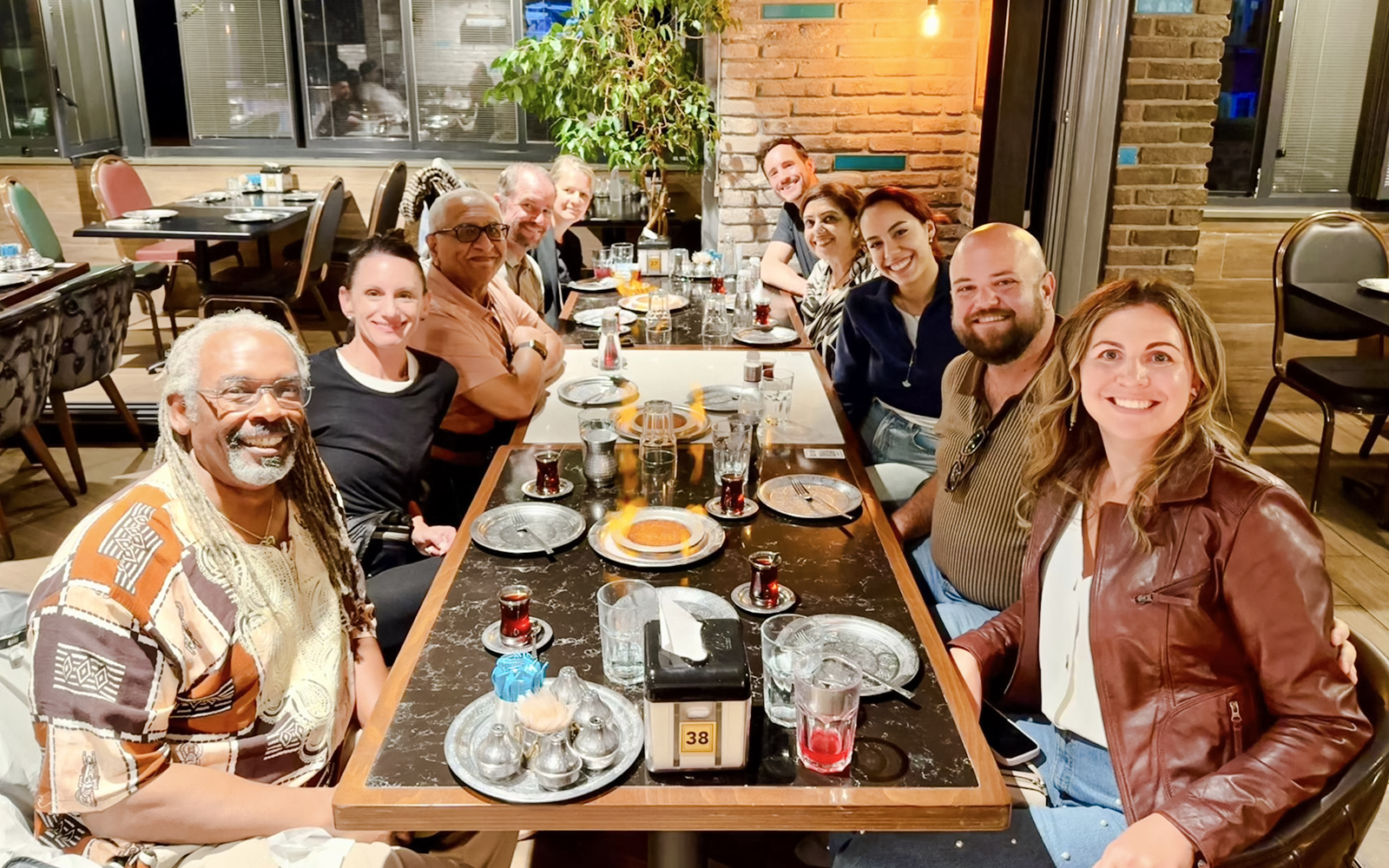 Group enjoying a traditional Turkish dinner with tea at a restaurant.