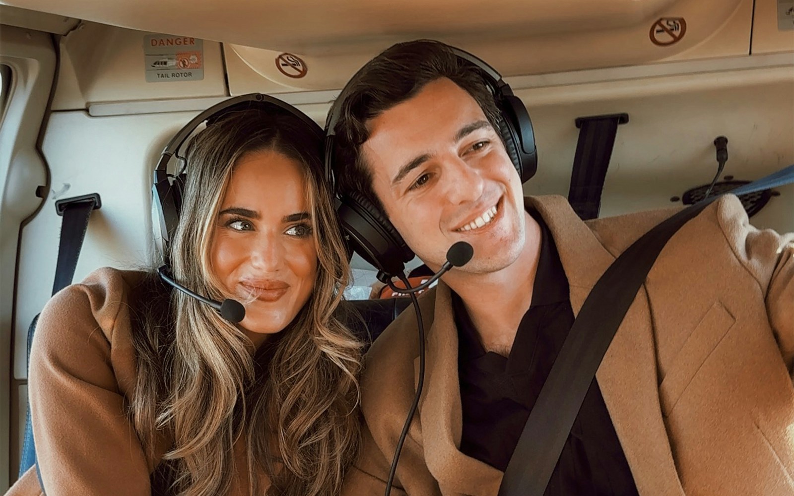 Couple wearing headsets inside a helicopter in New York City.