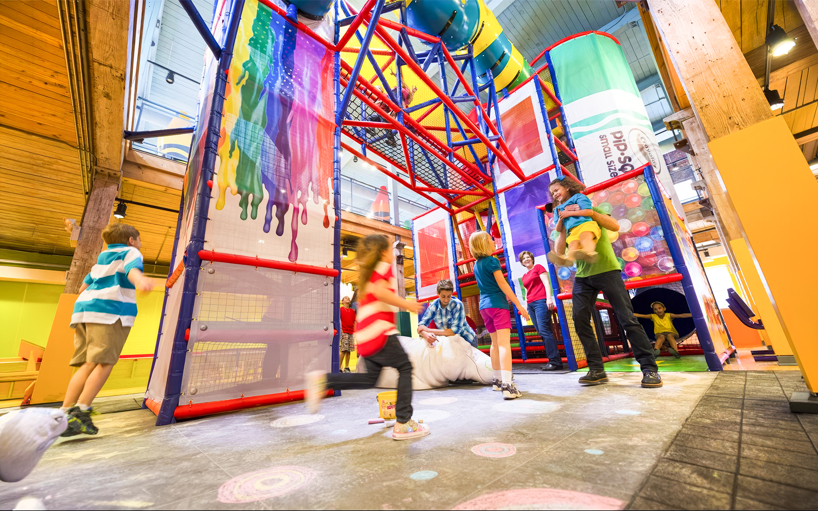 Children playing in the colorful indoor playground at Crayola Experience Orlando.