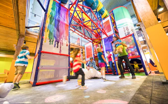 Children playing in the colorful indoor playground at Crayola Experience Orlando.