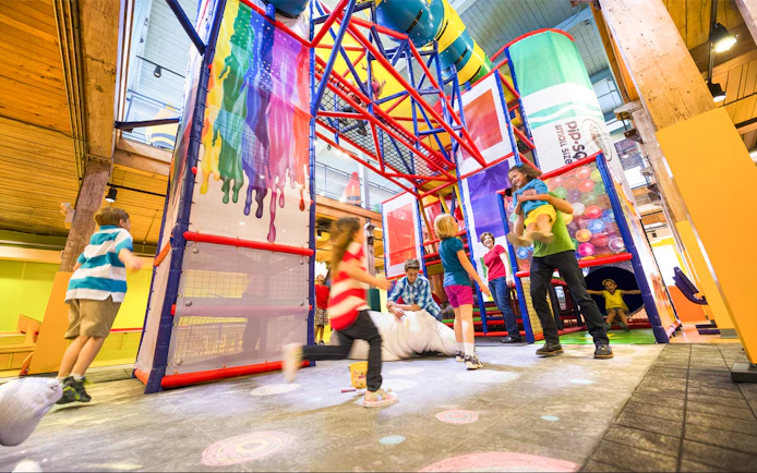 Children playing in the colorful indoor playground at Crayola Experience Orlando.