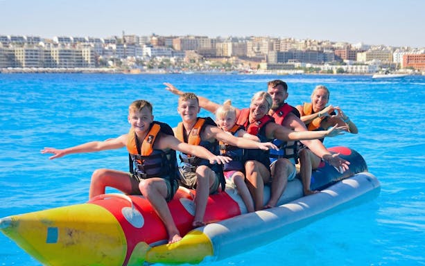 Group enjoying banana boat ride on Orange Bay Island, Hurghada.