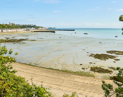 Mont Saint Michel bay view with tidal flats during day trip in Normandy, France.