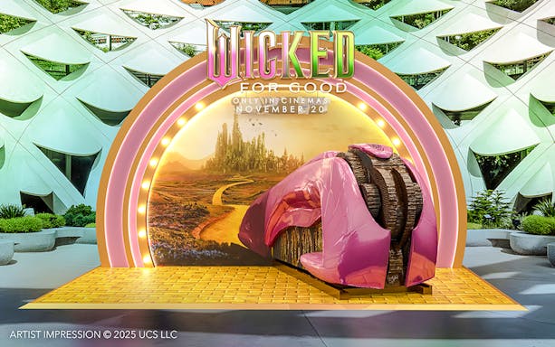 Wicked for Good display at Universal Studios Singapore featuring a pink shoe and Emerald City backdrop.