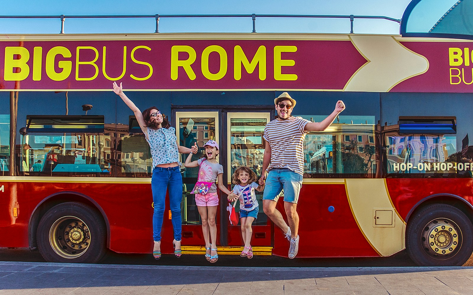 Family boarding Big Bus for Rome sightseeing tour near Colosseum.