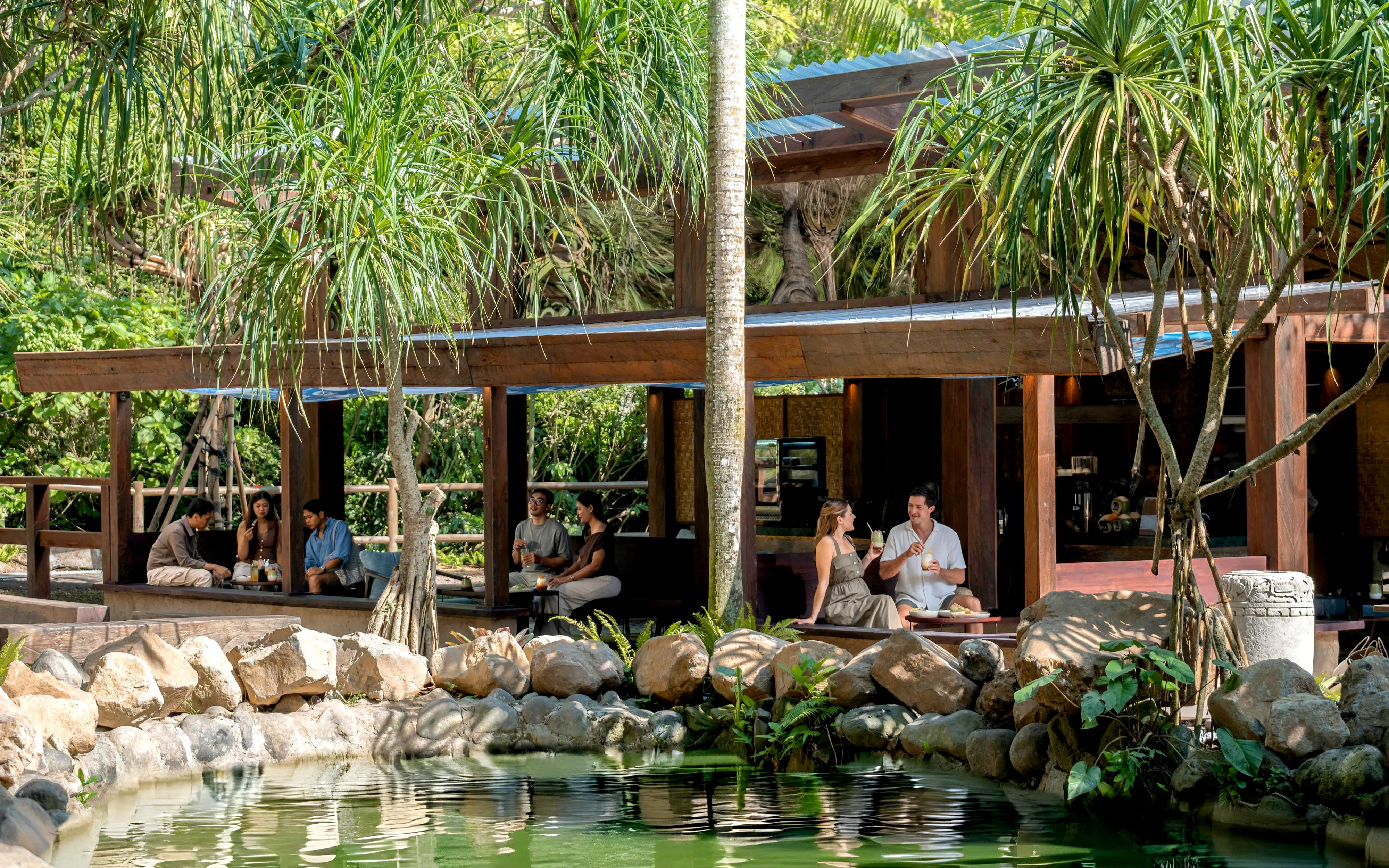 Visitors relaxing at a cafe in a lush setting during the Elephant Explorer Bali tour.
