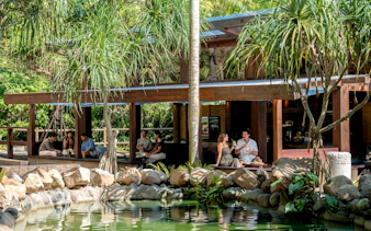 Visitors relaxing at a cafe in a lush setting during the Elephant Explorer Bali tour.