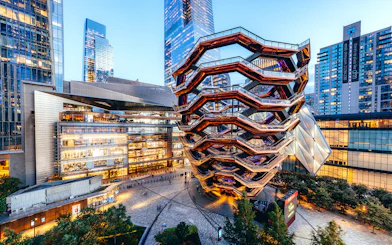 Vessel structure in Hudson Yards, New York City, surrounded by modern buildings.