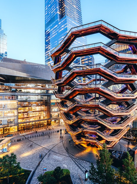 Vessel structure in Hudson Yards, New York City, surrounded by modern buildings.