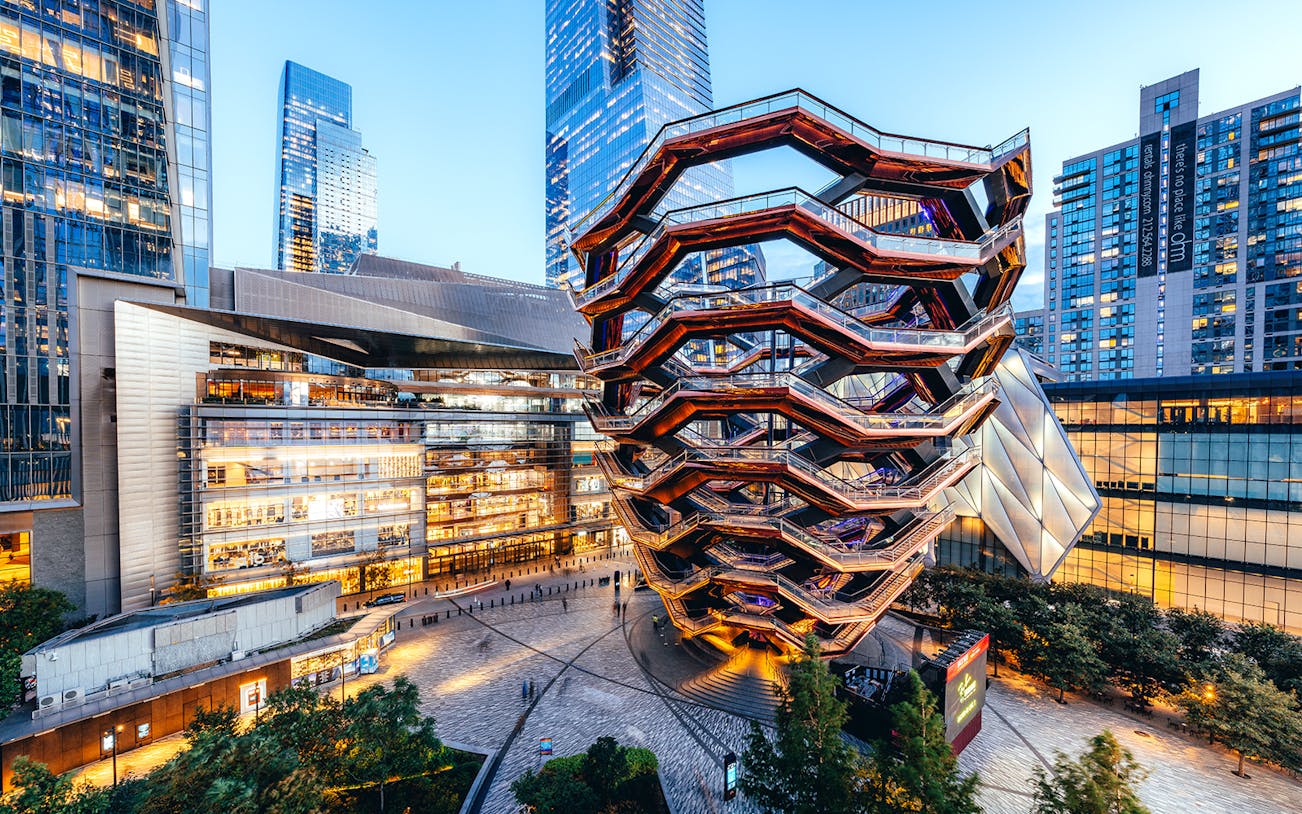 Vessel structure in Hudson Yards, New York City, surrounded by modern buildings.