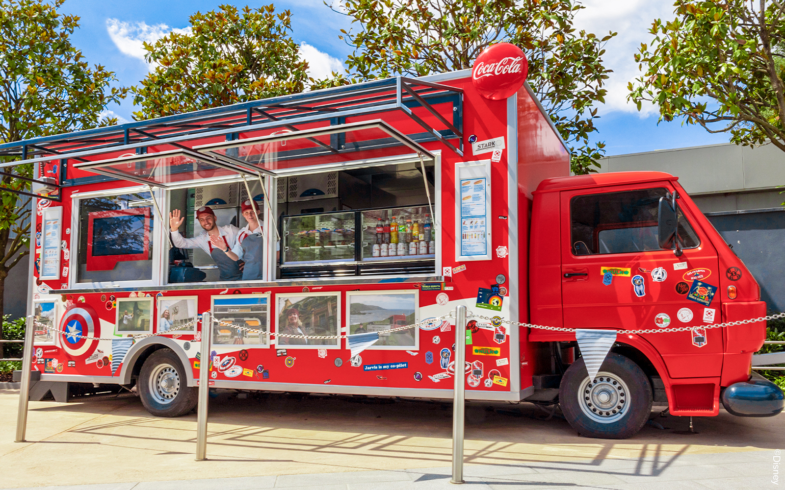 Red food truck with Marvel-themed decor at Disneyland Paris.