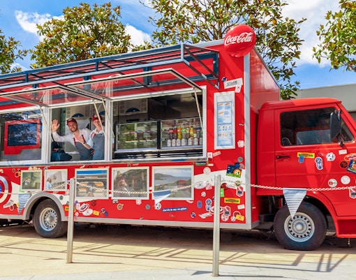 Red food truck with Marvel-themed decor at Disneyland Paris.