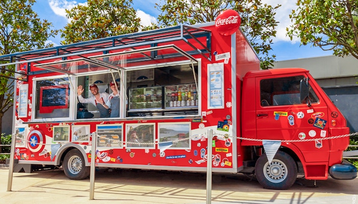 Red food truck with Marvel-themed decor at Disneyland Paris.
