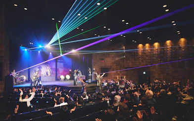 DRUM TAO performance with laser lights at Kyoto theater, audience clapping.