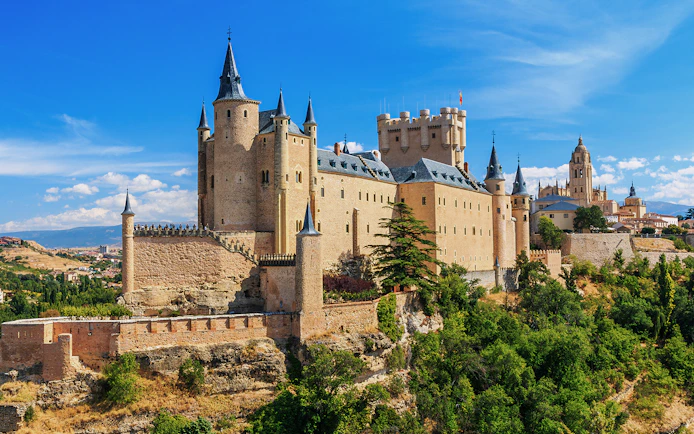 Segovia Alcazar castle with turrets and surrounding landscape in Spain.