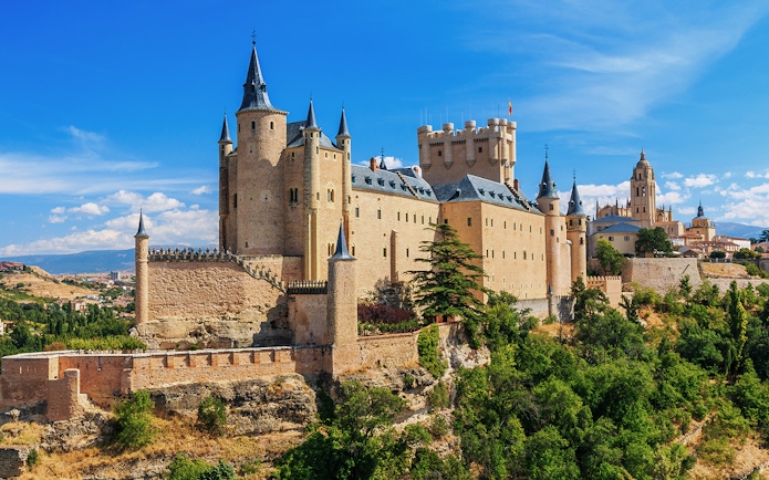 Segovia Alcazar castle with turrets and surrounding landscape in Spain.