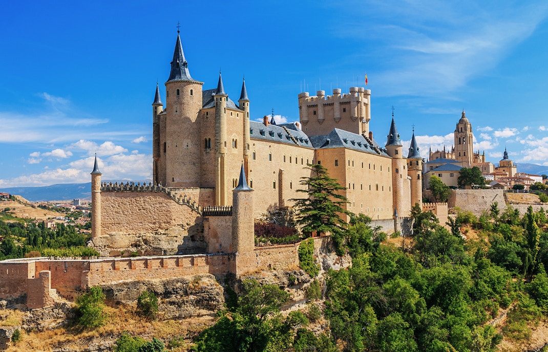 Segovia Alcazar castle with turrets and surrounding landscape in Spain.