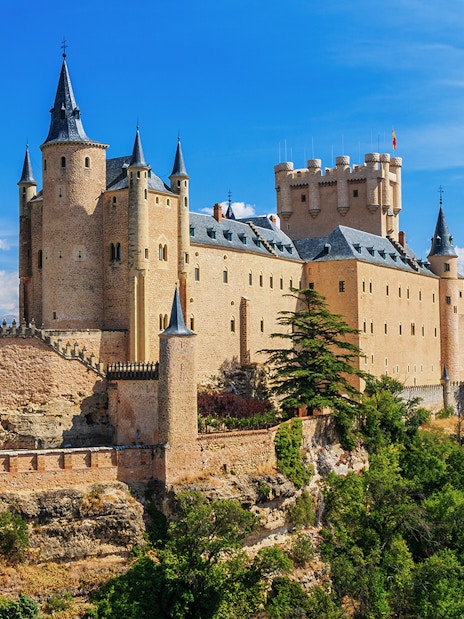 Segovia Alcazar castle with turrets and surrounding landscape in Spain.