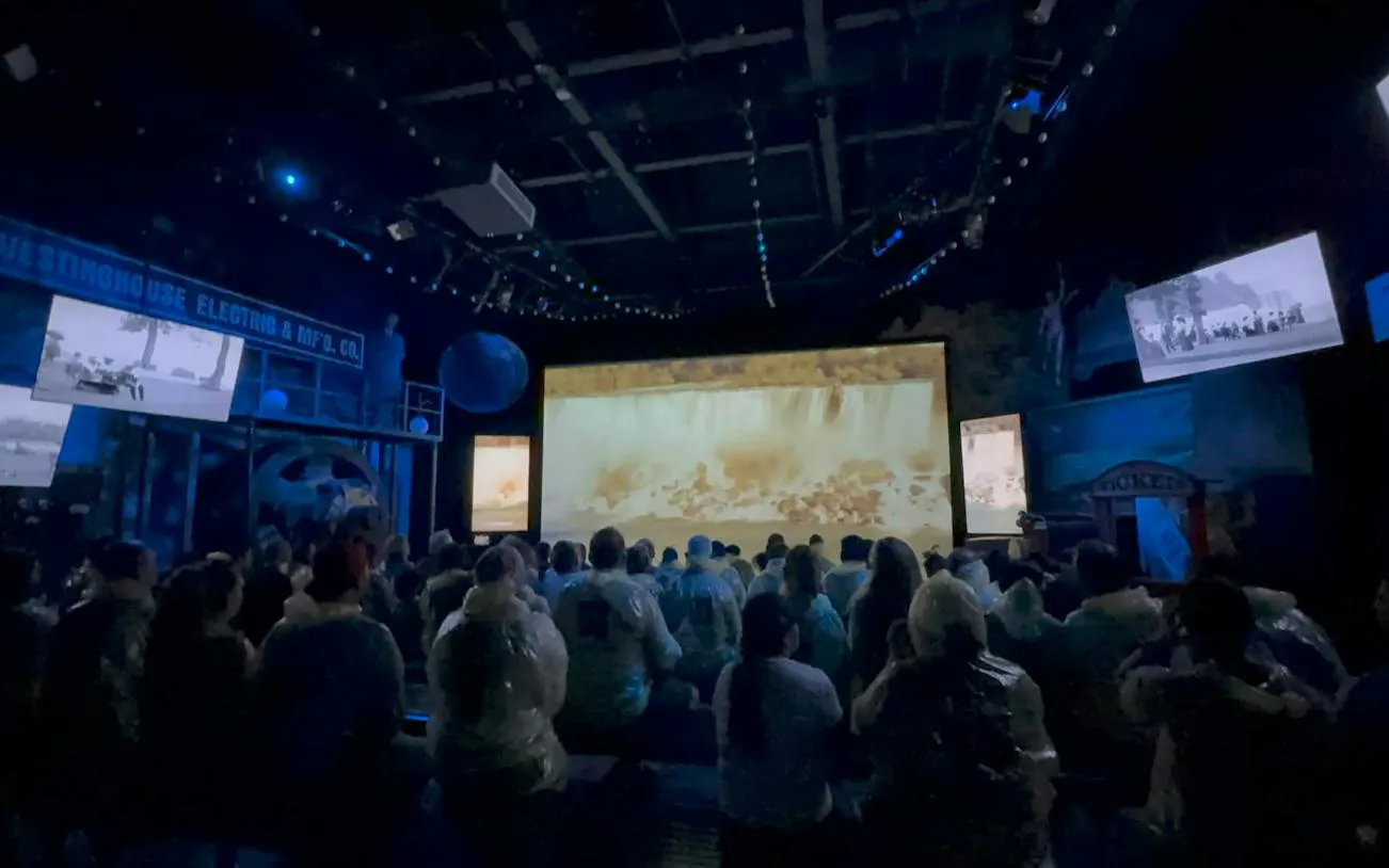 Visitors watching Niagara Falls film in theater during winter tour, Niagara Falls, USA.