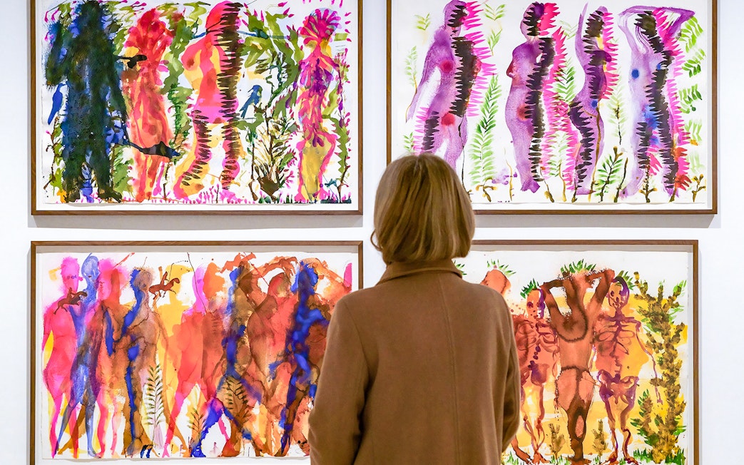 Visitor viewing colorful abstract paintings at Picasso Museum Malaga.