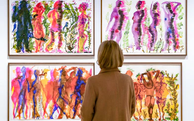 Visitor viewing colorful abstract paintings at Picasso Museum Malaga.