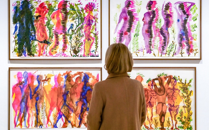 Visitor viewing colorful abstract paintings at Picasso Museum Malaga.