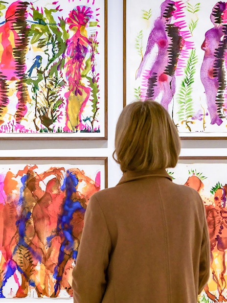 Visitor viewing colorful abstract paintings at Picasso Museum Malaga.