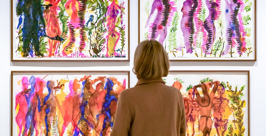 Visitor viewing colorful abstract paintings at Picasso Museum Malaga.
