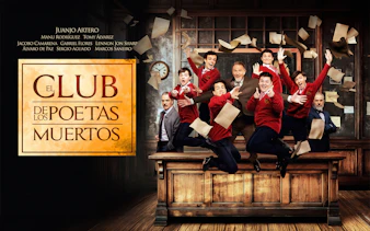 Group of people in red sweaters jumping on a desk with papers flying, related to Dead Poets Society.