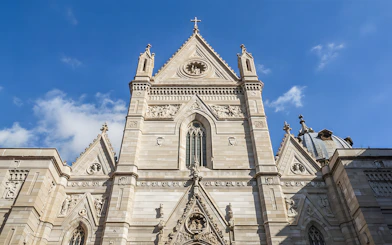 Sansevero Chapel facade with intricate sculptures and architectural details under a blue sky.