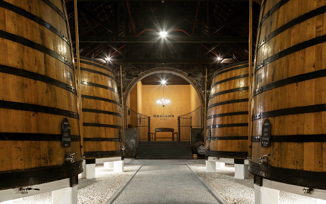 Graham’s Port Lodge interior with large wooden wine barrels.