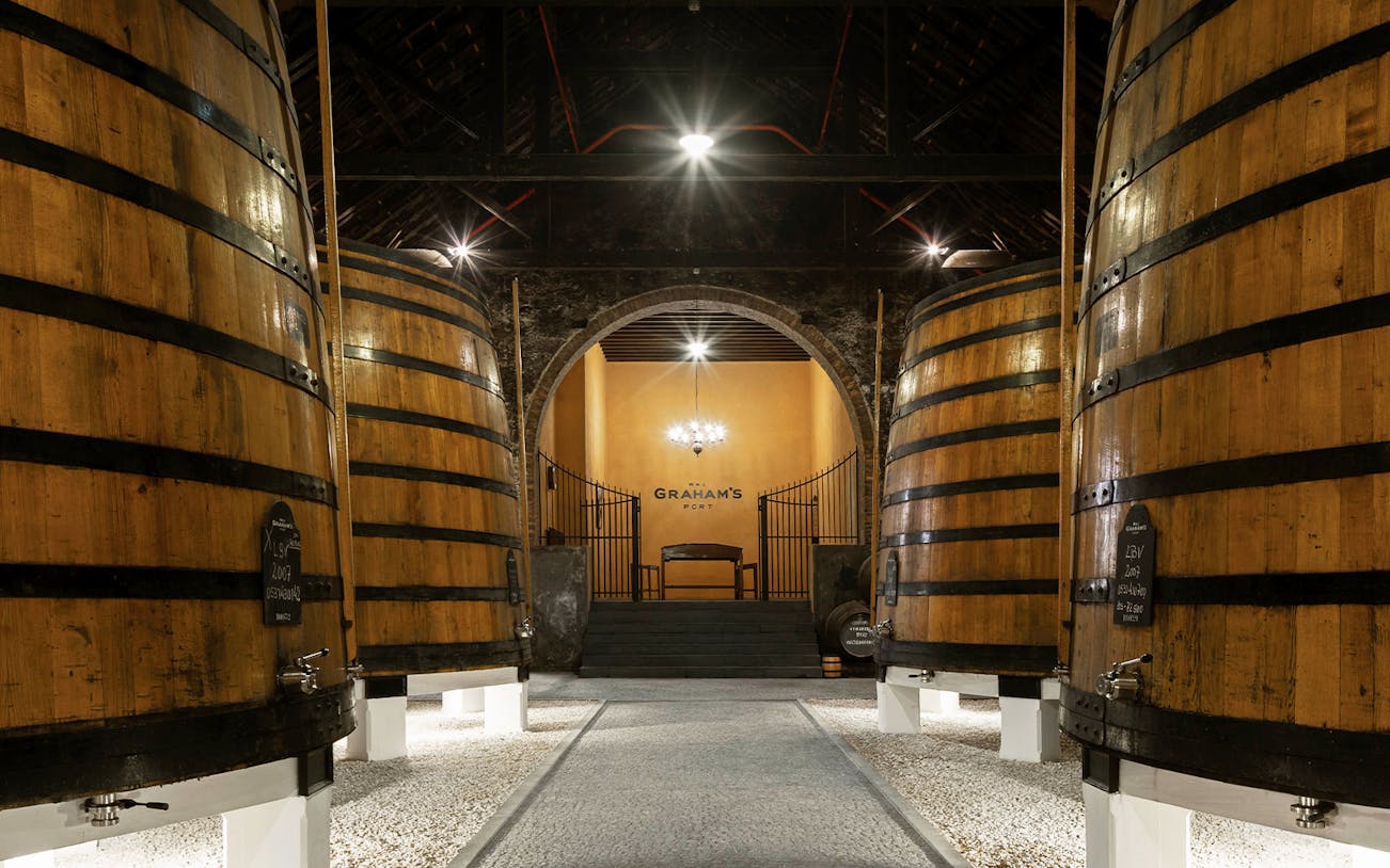 Graham’s Port Lodge interior with large wooden wine barrels.