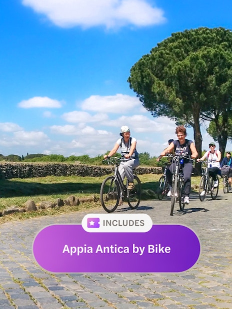 Cyclists riding along the ancient Appia Antica road in Rome, surrounded by greenery.
