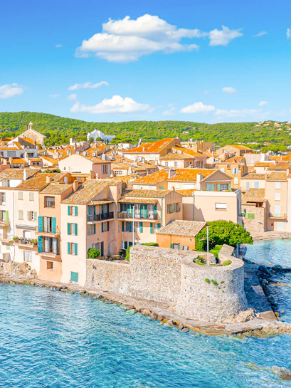 Saint-Tropez coastal view with historic buildings and blue sea, Provence, Cote d'Azur.