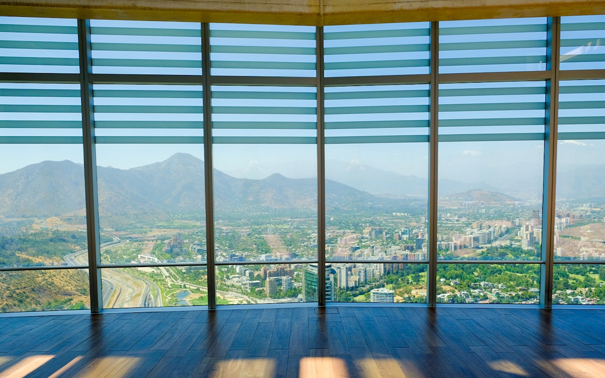 Observation deck view of Santiago, Chile from Sky Costanera, overlooking cityscape and mountains.