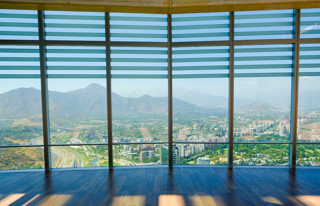Observation deck view of Santiago, Chile from Sky Costanera, overlooking cityscape and mountains.
