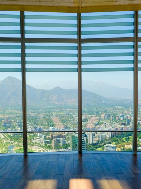 Observation deck view of Santiago, Chile from Sky Costanera, overlooking cityscape and mountains.