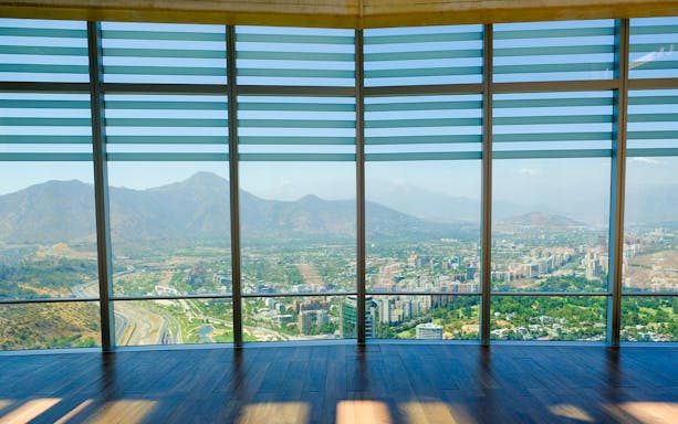 Observation deck view of Santiago, Chile from Sky Costanera, overlooking cityscape and mountains.