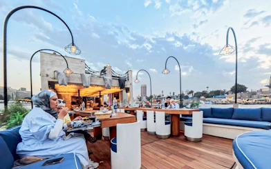 Open-air dining on Nile Dahabiya cruise in Cairo with guests enjoying drinks and dinner.