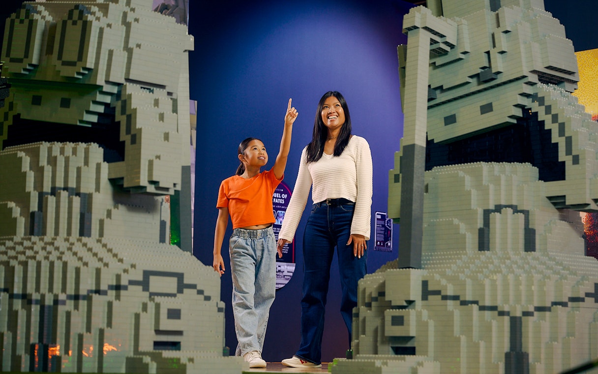 Child and adult admiring LEGO Star Wars sculptures at LEGOStarWarsTheExhibition.
