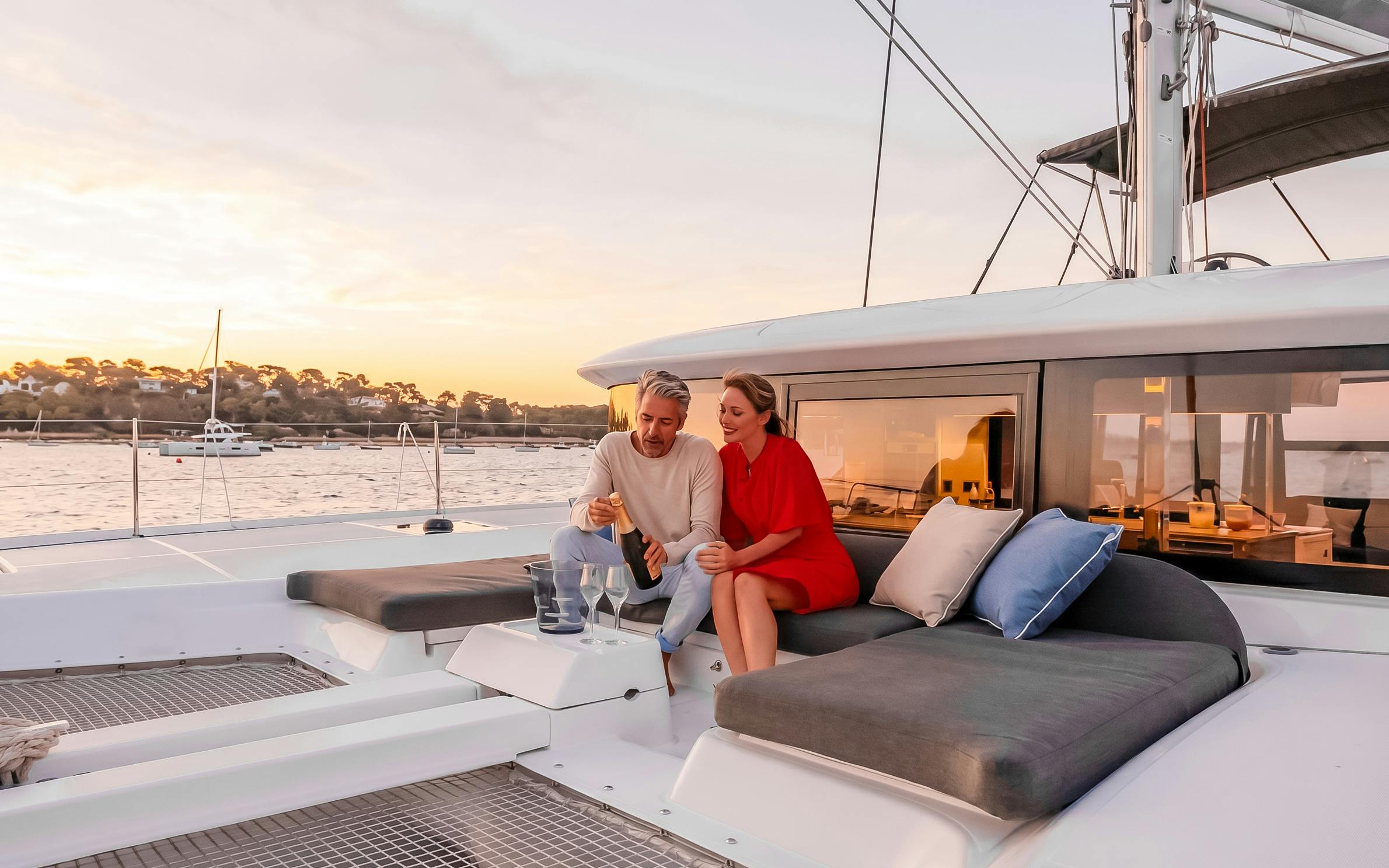 Couple enjoying champagne on a Heraklion catamaran cruise at sunset.