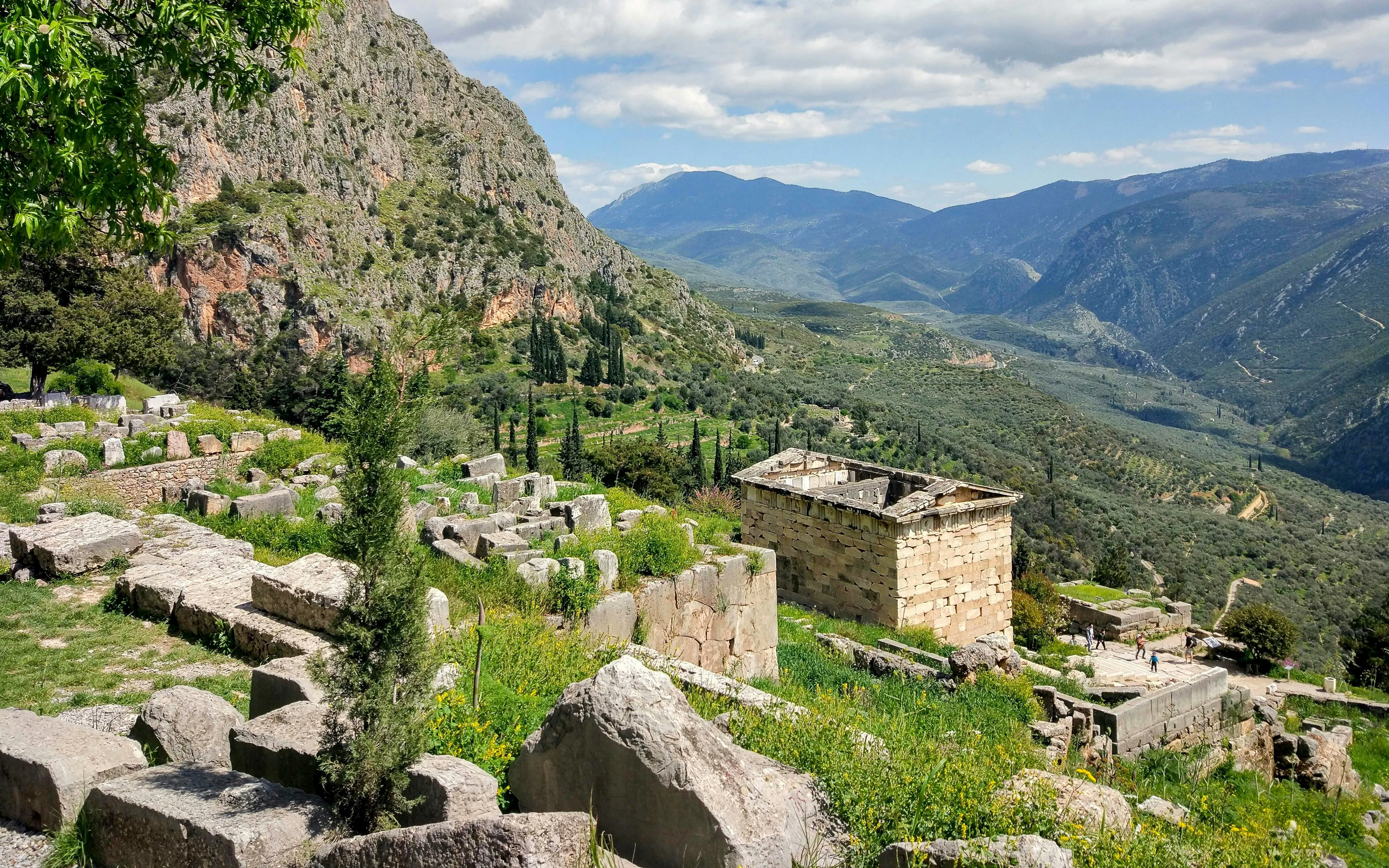 Ancient ruins at Delphi with mountainous landscape, Greece, on a guided tour from Athens.