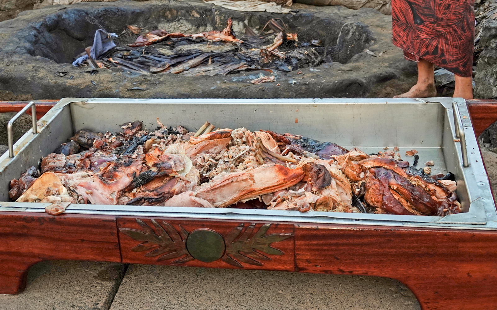 Pork cooked underground in the kalua tradition of Hawaii, displayed in a serving tray.