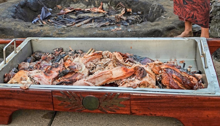 Pork cooked underground in the kalua tradition of Hawaii, displayed in a serving tray.