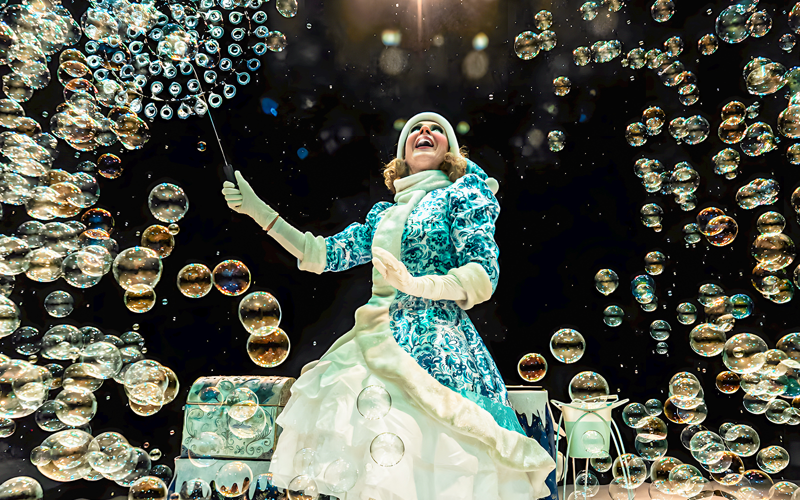 Performer creating bubbles at PortAventura's Bubble Magic Christmas show.