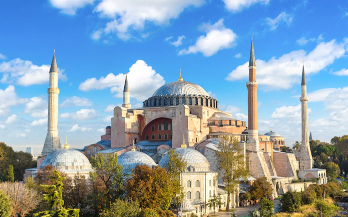 Hagia Sophia with minarets under a blue sky in Istanbul.