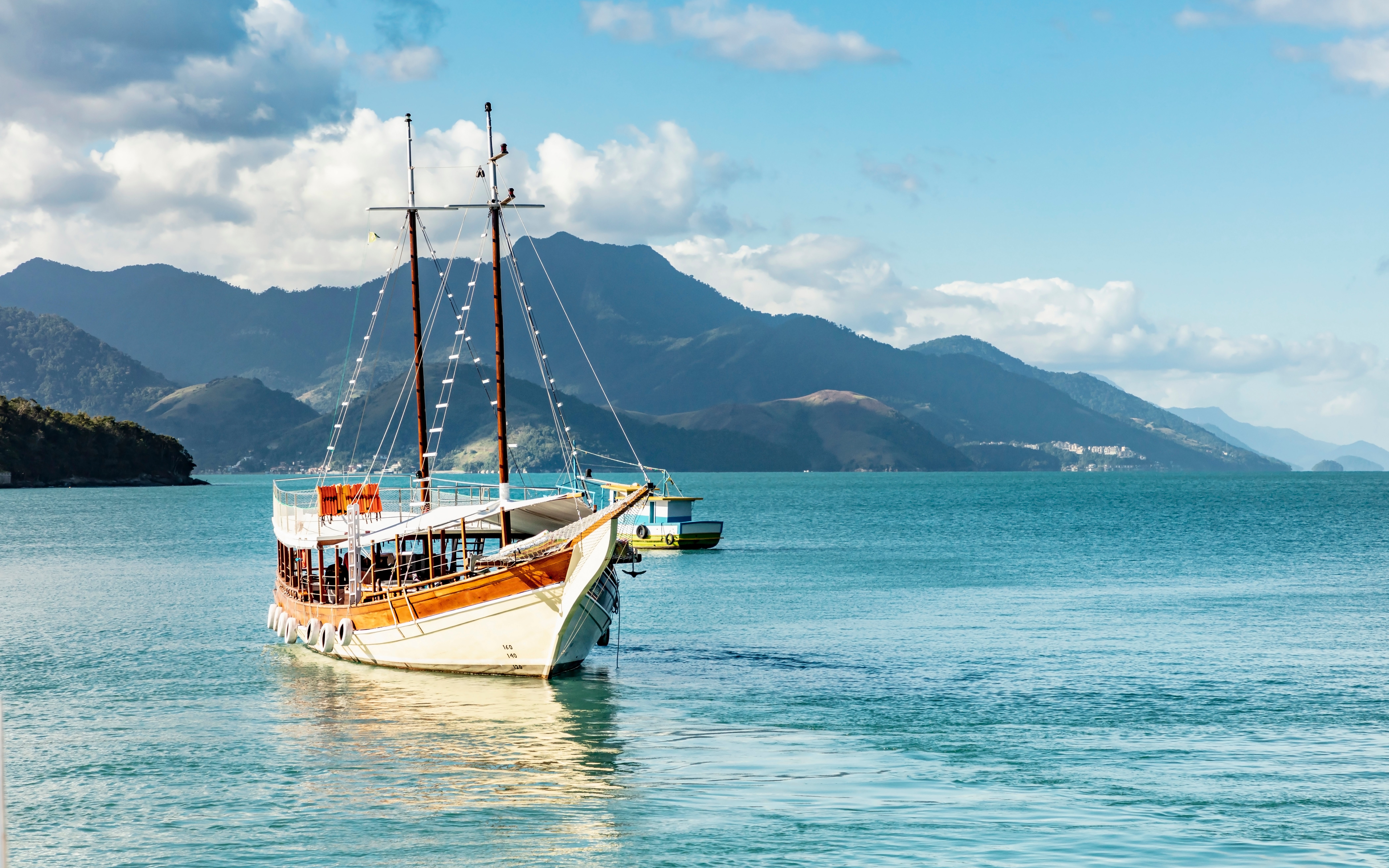 Schooner sailing in Angra dos Reis bay with Ilha Grande mountains, Rio de Janeiro, Brazil.